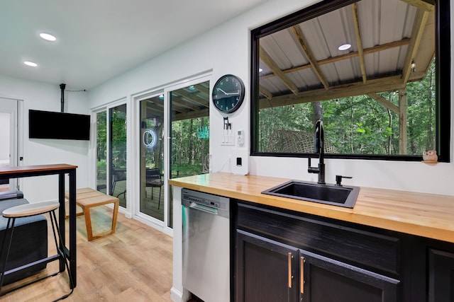 275 Fairview E, Livingston, TX 77351 - kitchen featuring butcher block countertops, stainless steel dishwasher, a sink, recessed lighting, and light wood-style floors