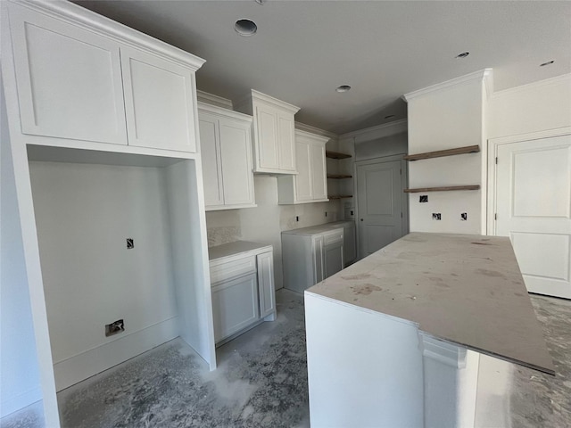 118 Capetown, Conroe, TX 77356 - kitchen with open shelves, unfinished concrete flooring, a kitchen island, white cabinets, and ornamental molding