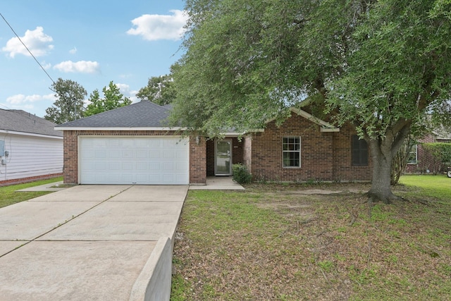 view of front facade with a garage, driveway, brick siding, and a front yard