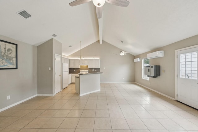 unfurnished living room featuring a ceiling fan, a wall mounted AC, beam ceiling, light tile patterned floors, and baseboards