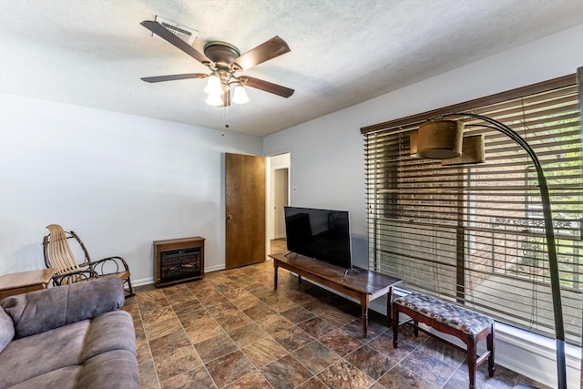 229 Willowbend St, Huntsville, TX 77320 - living area featuring ceiling fan, stone finish flooring, and baseboards