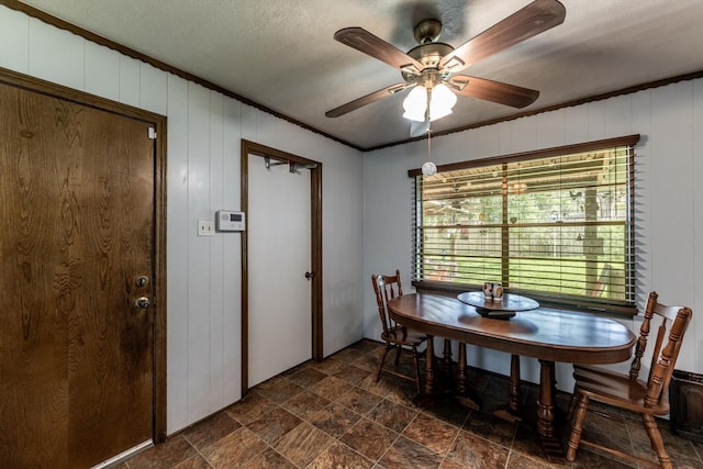 229 Willowbend St, Huntsville, TX 77320 - dining space with dark stone finish flooring, a ceiling fan, and crown molding