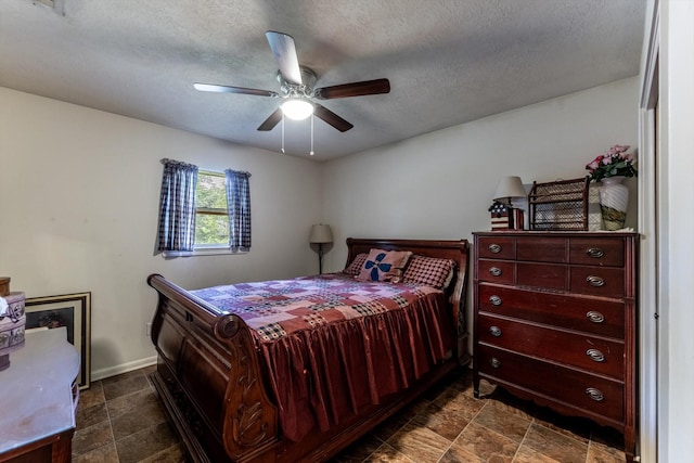 229 Willowbend St, Huntsville, TX 77320 - bedroom featuring baseboards, a textured ceiling, and a ceiling fan