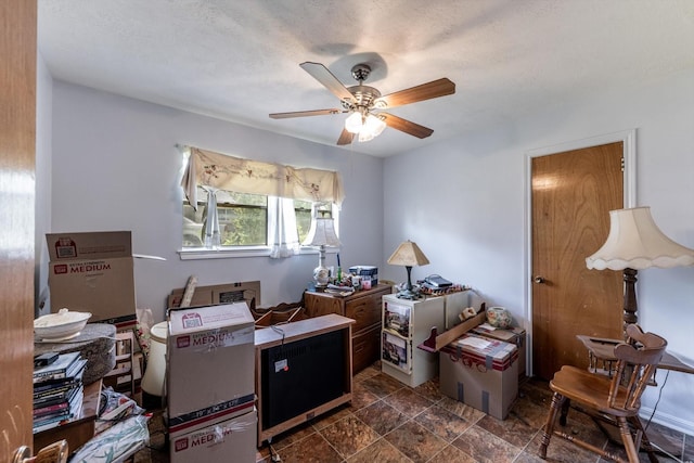 229 Willowbend St, Huntsville, TX 77320 - miscellaneous room featuring a ceiling fan and dark stone finish flooring