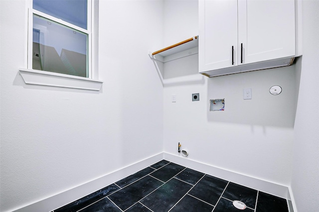 1913 Hoskins Dr Unit D, Houston, TX 77080 - laundry room featuring gas dryer hookup, cabinet space, washer hookup, hookup for an electric dryer, and dark tile patterned floors