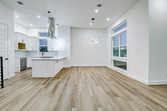 1913 Hoskins Dr Unit D, Houston, TX 77080 - kitchen with dishwasher, a sink, a chandelier, a peninsula, and light countertops