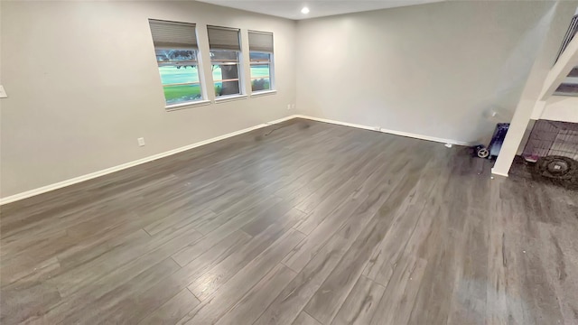 2263 Triway Ln, Houston, TX 77043 - unfurnished living room featuring dark wood-type flooring, baseboards, and recessed lighting