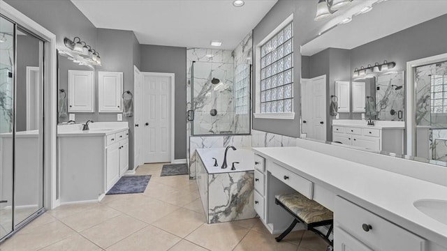 13402 Layton Castle Ln, Cypress, TX 77429 - full bathroom featuring a stall shower, tile patterned floors, a garden tub, two vanities, and baseboards