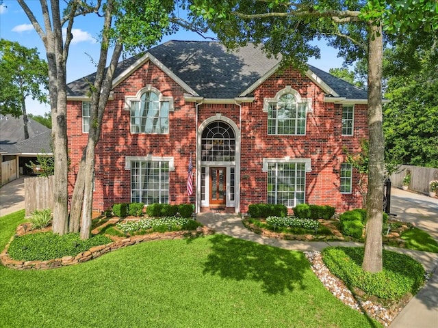 13402 Layton Castle Ln, Cypress, TX 77429 - view of front of home featuring roof with shingles, brick siding, and french doors