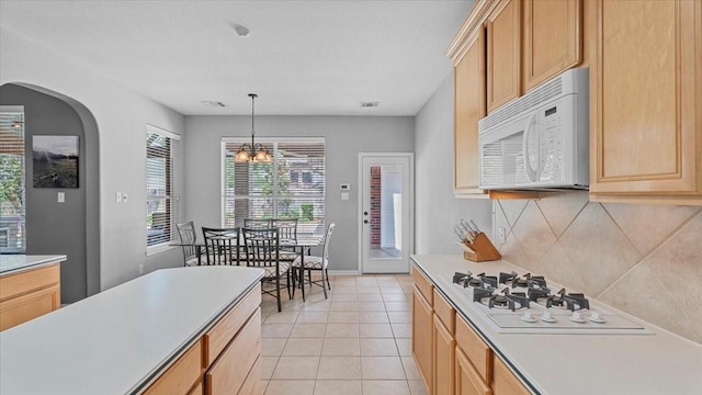 13402 Layton Castle Ln, Cypress, TX 77429 - kitchen featuring white appliances, light countertops, backsplash, and light tile patterned floors