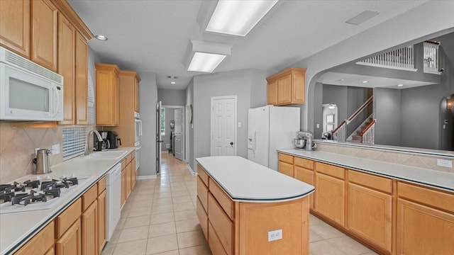 13402 Layton Castle Ln, Cypress, TX 77429 - kitchen featuring white appliances, a sink, a center island, light tile patterned flooring, and recessed lighting
