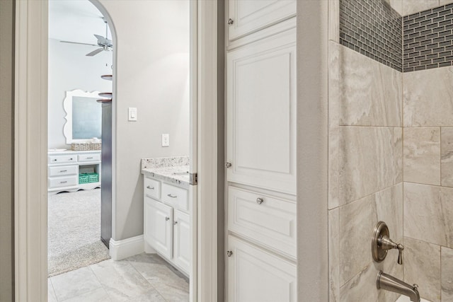 32319 Tall Oaks Way, Magnolia, TX 77354 - full bath featuring vanity, a ceiling fan, washtub / shower combination, and marble look tile flooring