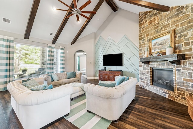 32319 Tall Oaks Way, Magnolia, TX 77354 - living room featuring arched walkways, a ceiling fan, dark wood-style floors, a stone fireplace, and high vaulted ceiling