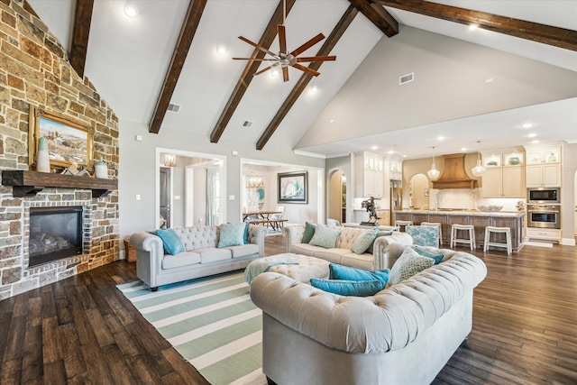 32319 Tall Oaks Way, Magnolia, TX 77354 - living area featuring a fireplace, high vaulted ceiling, dark wood-style flooring, beamed ceiling, and ceiling fan