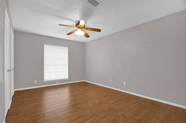 6214 Oak Masters Dr, Spring, TX 77379 - unfurnished room featuring ceiling fan, baseboards, wood finished floors, and a textured ceiling