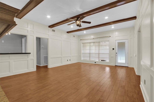 6214 Oak Masters Dr, Spring, TX 77379 - unfurnished living room with a decorative wall, a ceiling fan, beamed ceiling, and wood finished floors