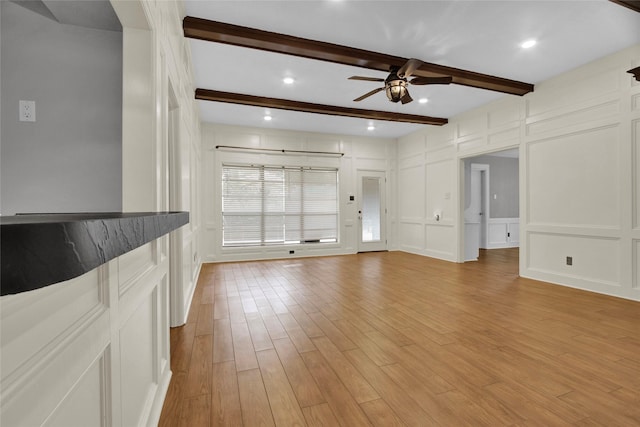 6214 Oak Masters Dr, Spring, TX 77379 - unfurnished living room featuring a ceiling fan, a decorative wall, light wood-type flooring, and beam ceiling
