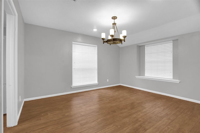6214 Oak Masters Dr, Spring, TX 77379 - spare room with a chandelier, baseboards, and dark wood finished floors