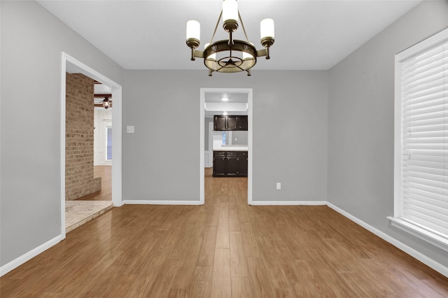 6214 Oak Masters Dr, Spring, TX 77379 - unfurnished dining area featuring a chandelier, wood finished floors, baseboards, and ceiling fan