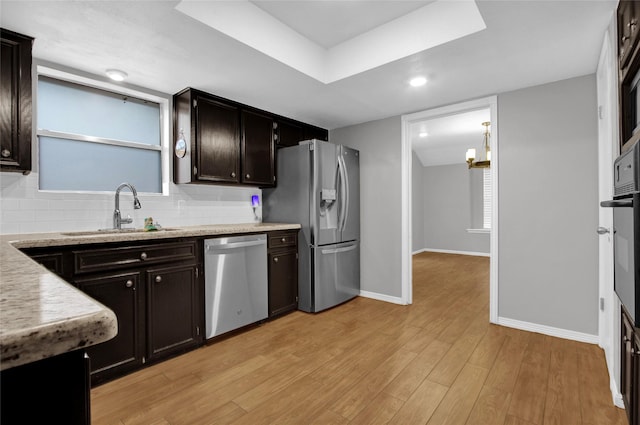 6214 Oak Masters Dr, Spring, TX 77379 - kitchen with a sink, appliances with stainless steel finishes, baseboards, and backsplash