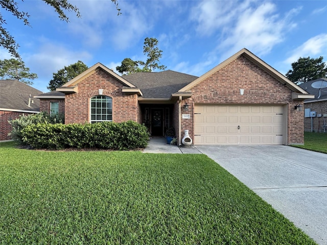 969 Gowan Dr, Conroe, TX 77301 - view of front of house with brick siding, a garage, a front lawn, concrete driveway, and a shingled roof