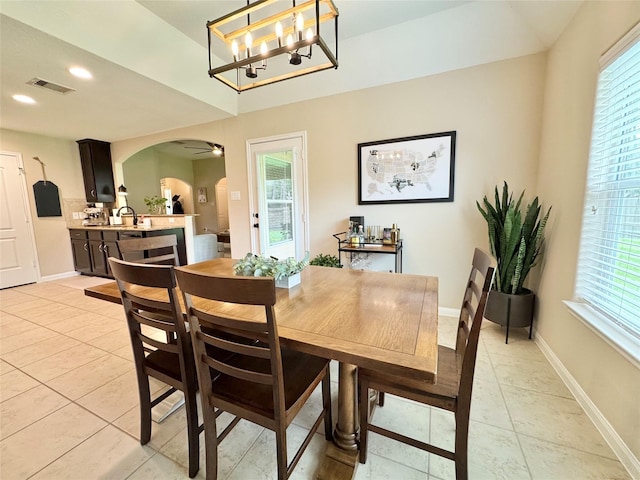969 Gowan Dr, Conroe, TX 77301 - dining area with arched walkways, plenty of natural light, light tile patterned flooring, baseboards, and recessed lighting