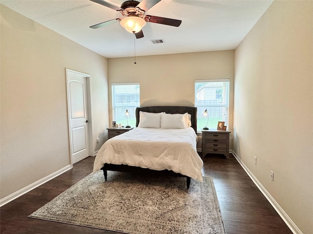 969 Gowan Dr, Conroe, TX 77301 - bedroom with dark wood-style flooring, baseboards, and a ceiling fan