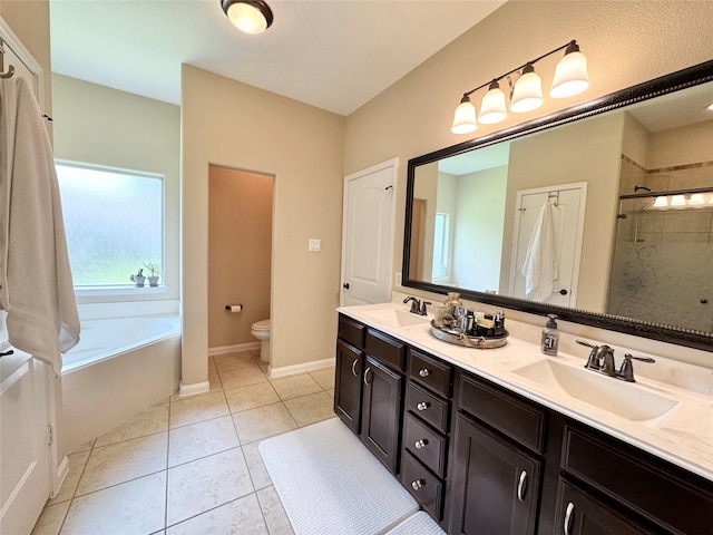 969 Gowan Dr, Conroe, TX 77301 - bathroom with toilet, tile patterned floors, double vanity, a bath, and tiled shower