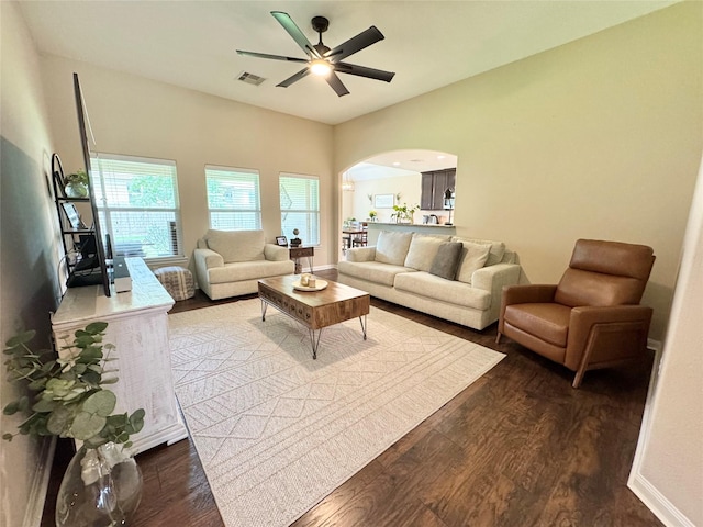 969 Gowan Dr, Conroe, TX 77301 - living room featuring arched walkways, dark wood-type flooring, a ceiling fan, and baseboards