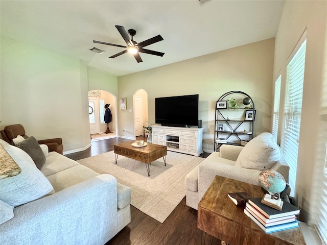 969 Gowan Dr, Conroe, TX 77301 - living area featuring arched walkways, a ceiling fan, wood finished floors, baseboards, and healthy amount of natural light