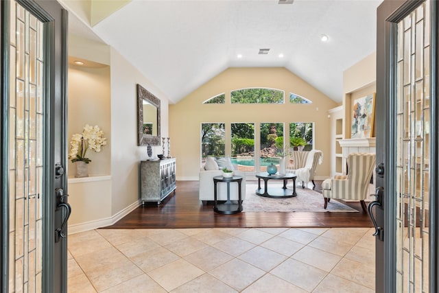 entryway with tile patterned flooring, lofted ceiling, recessed lighting, and french doors