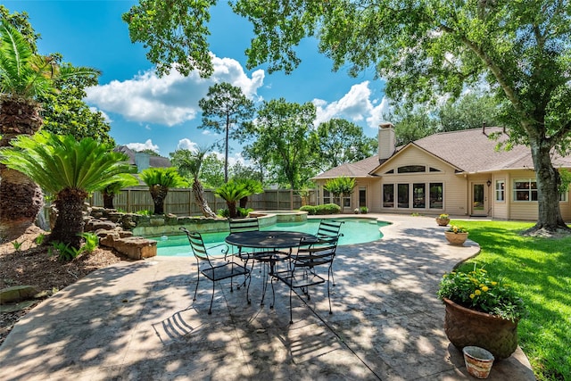 view of pool featuring a fenced backyard, a patio area, and a jacuzzi