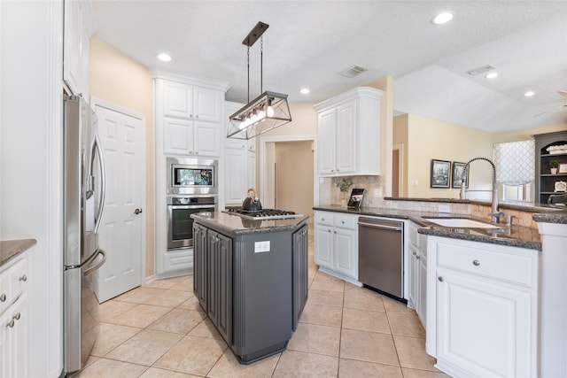kitchen featuring stainless steel appliances, a sink, white cabinets, light tile patterned flooring, and recessed lighting