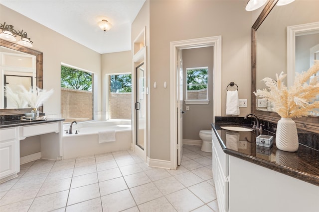 bathroom featuring toilet, a garden tub, a stall shower, tile patterned floors, and vanity
