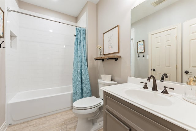 bathroom featuring toilet, shower / tub combo with curtain, vanity, and wood finished floors