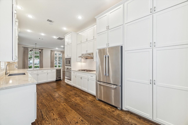 1206 Lake Pointe Pkwy, Sugar Land, TX 77478 - kitchen with appliances with stainless steel finishes, a sink, beverage cooler, under cabinet range hood, and white cabinets