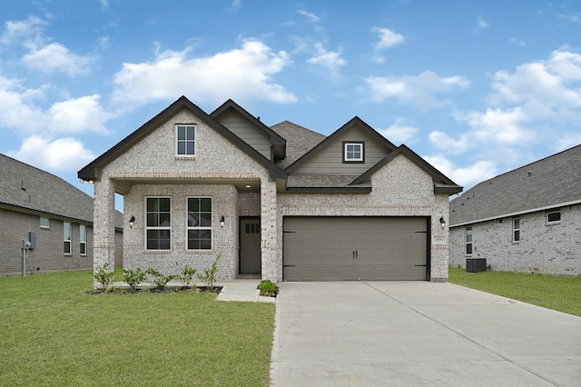 400 Little Spring Ct, Anahuac, TX 77514 - view of front of home featuring brick siding, concrete driveway, a front lawn, central AC, and an attached garage