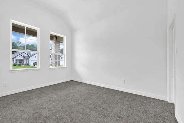 400 Little Spring Ct, Anahuac, TX 77514 - empty room featuring vaulted ceiling, dark colored carpet, and baseboards