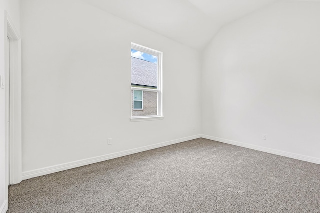 400 Little Spring Ct, Anahuac, TX 77514 - carpeted empty room featuring lofted ceiling and baseboards
