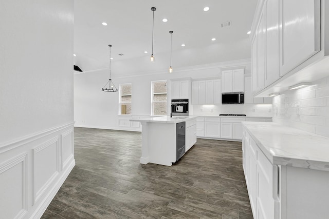 400 Little Spring Ct, Anahuac, TX 77514 - kitchen featuring stainless steel appliances, white cabinets, hanging light fixtures, backsplash, and a kitchen island