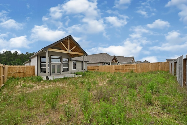 400 Little Spring Ct, Anahuac, TX 77514 - back of house with french doors and a fenced backyard
