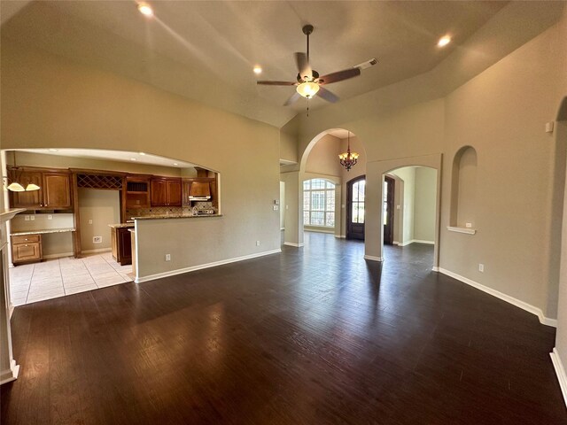305 Tyler Dr, Bridge City, TX 77630 - unfurnished living room featuring arched walkways, wood finished floors, ceiling fan, recessed lighting, and baseboards