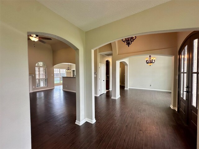 305 Tyler Dr, Bridge City, TX 77630 - spare room with dark wood-type flooring, a chandelier, french doors, and a ceiling fan