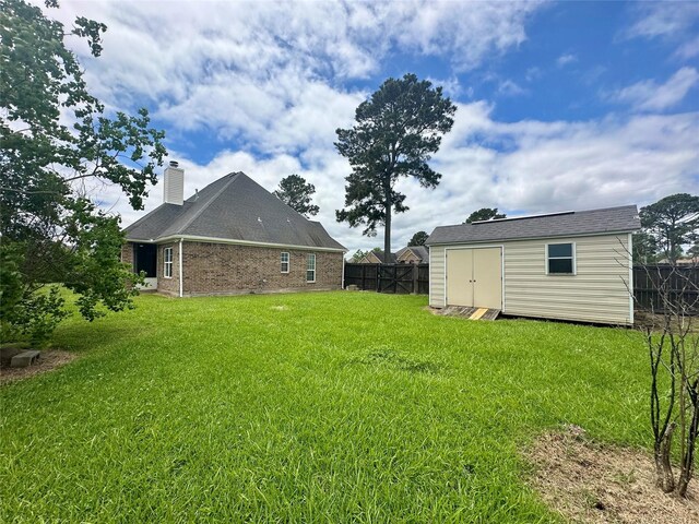 305 Tyler Dr, Bridge City, TX 77630 - view of yard featuring a storage shed and an outdoor structure