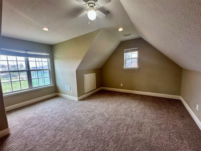 305 Tyler Dr, Bridge City, TX 77630 - additional living space featuring a textured ceiling, carpet flooring, baseboards, vaulted ceiling, and a ceiling fan