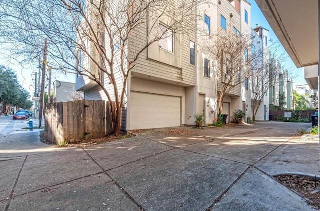 730 Ruthven, Houston, TX 77019 - view of side of home featuring stucco siding, a residential view, and fence