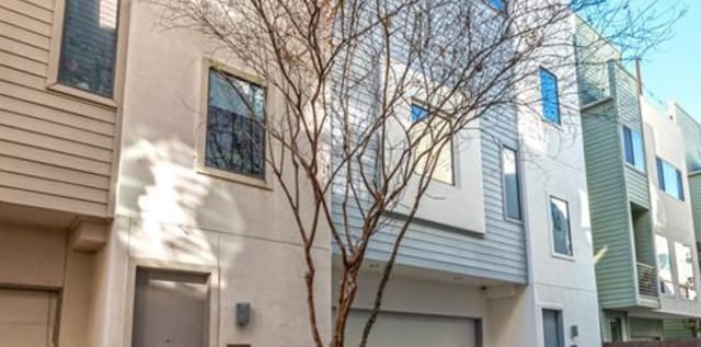 730 Ruthven, Houston, TX 77019 - view of side of property with stucco siding and an attached garage