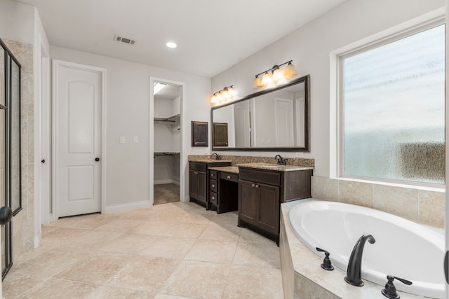 full bathroom with a bath, vanity, a shower stall, a spacious closet, and recessed lighting