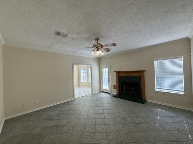 20215 Sapphire Cir, Magnolia, TX 77355 - unfurnished living room featuring crown molding, baseboards, a ceiling fan, a textured ceiling, and a fireplace with raised hearth