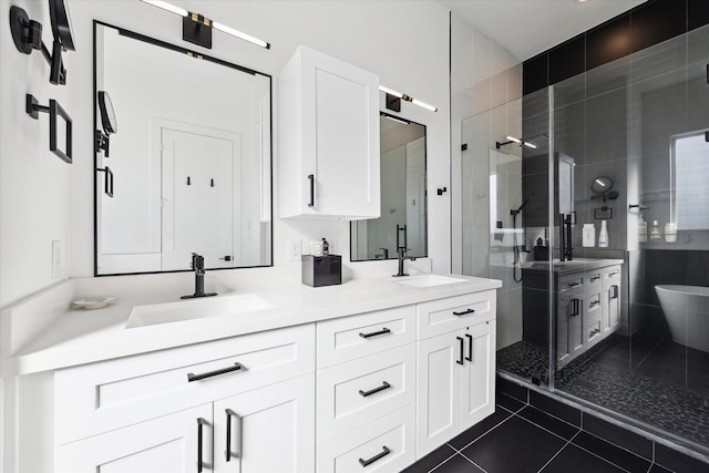830 E 40th St, Houston, TX 77022 - full bathroom featuring a stall shower, tile patterned floors, and double vanity